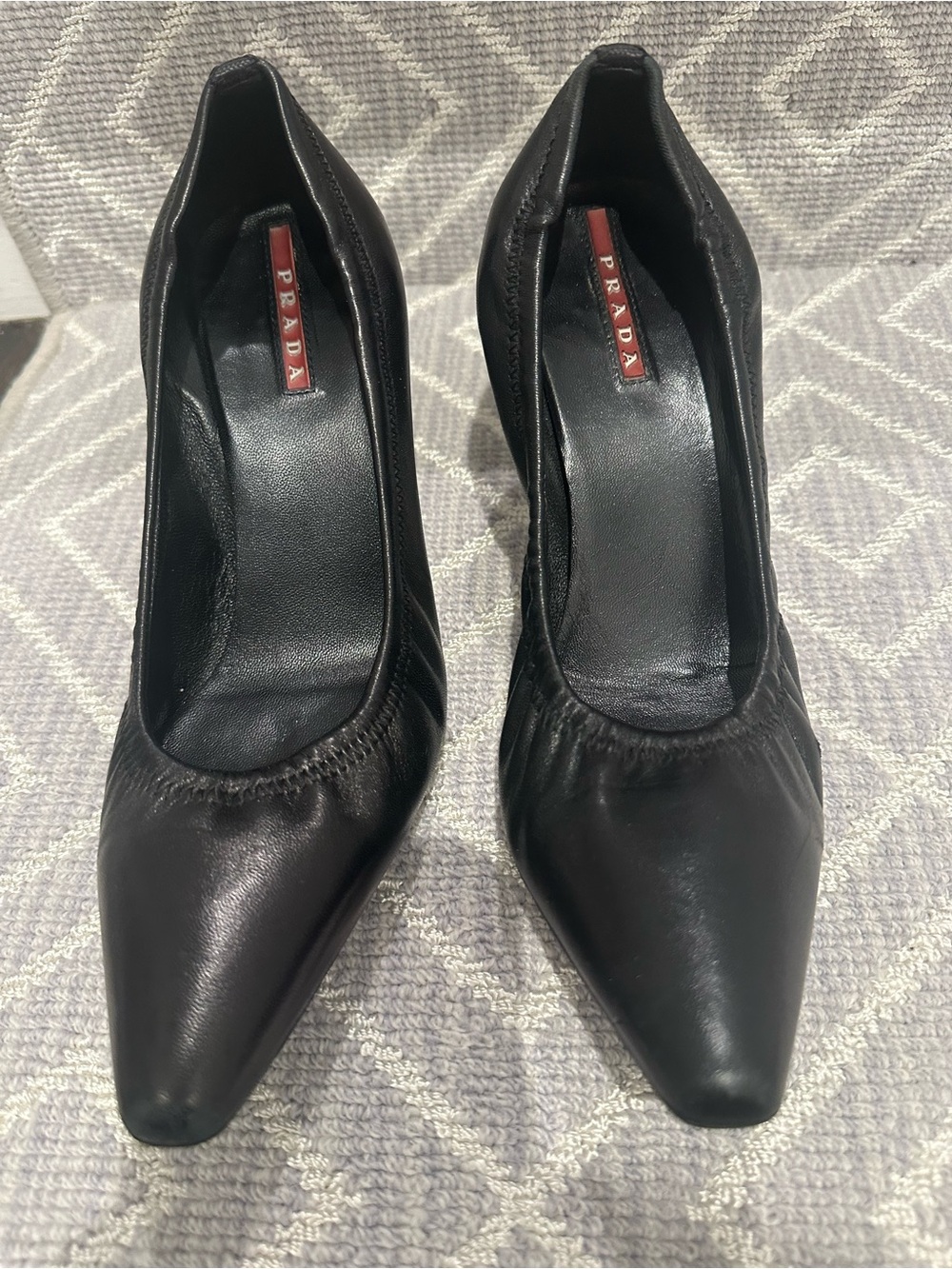 Prada Black Leather Pointed-Toe Pumps with Red Logo Tag